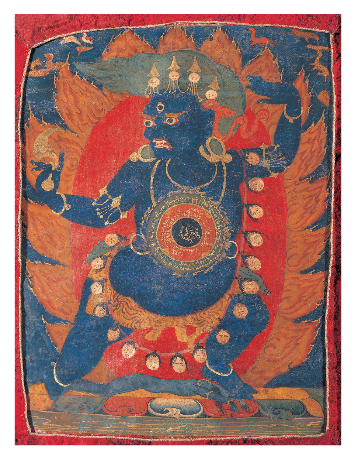 A yantra with a black center, four red petals, and an outer ring edged with flames